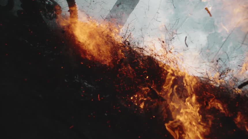 A bicycle riding through a forest fire slow motion