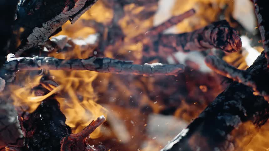 Close up of a pile of logs and twigs engulfed in flames