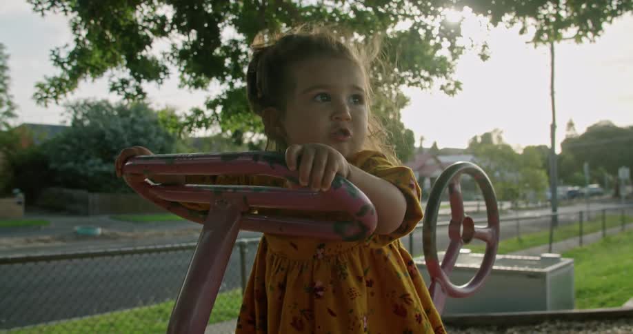 A child playing on a toy at a park