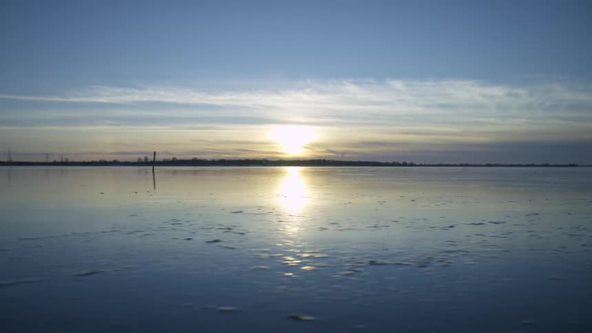 Sunset sunlight reflecting over the wet sand during low tide