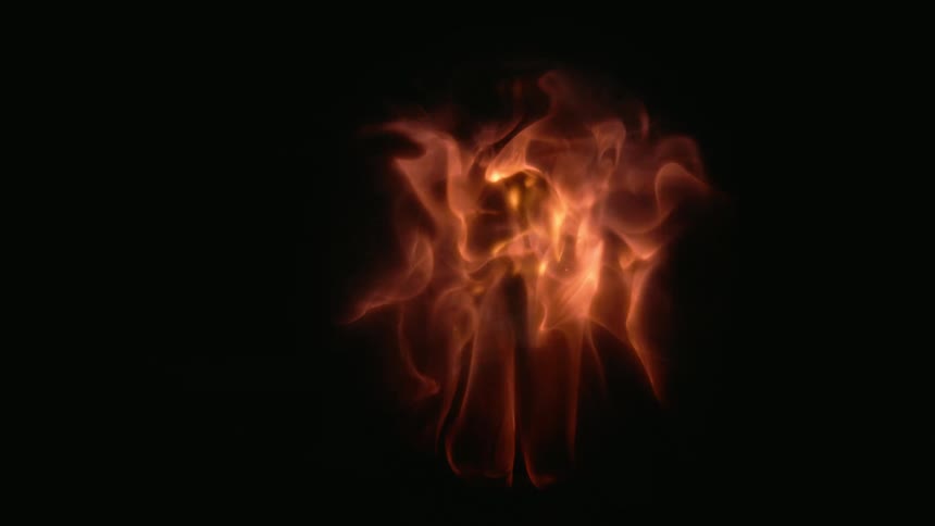 Fire bursts upward in the darkness and the flames are contained inside a clear globe