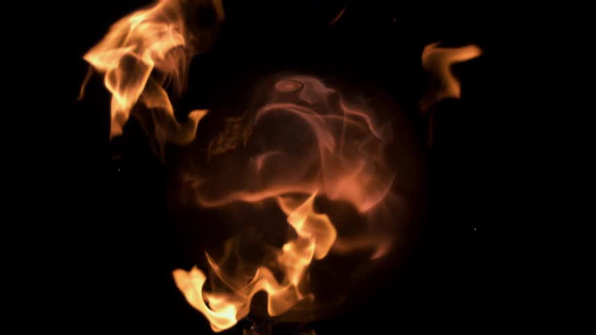 Orange flames dissipating inside a glass ball on a black background