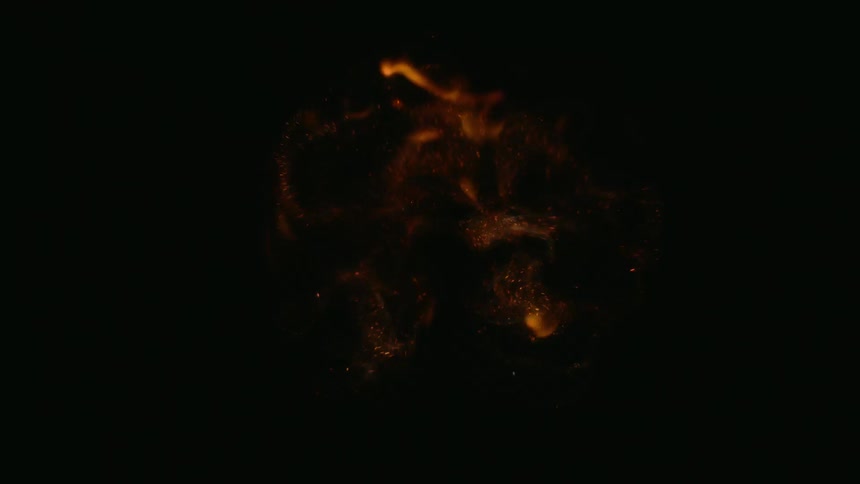 The flame shortly sparks in the dark