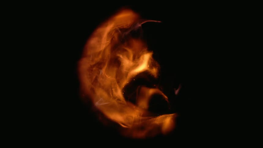 Orange flames dissipating inside a glass ball on a black background