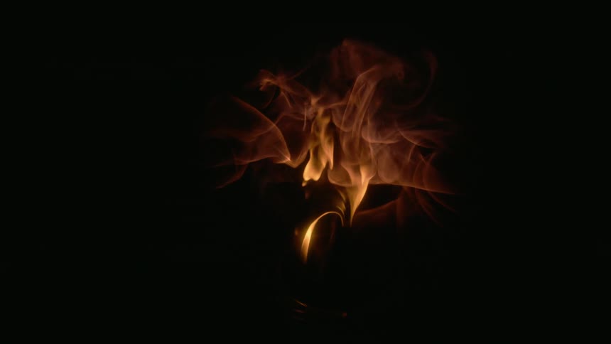 Flames burst into a circular shape in the darkness