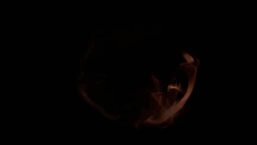 Sparks and flames burst into a circular shape in the darkness