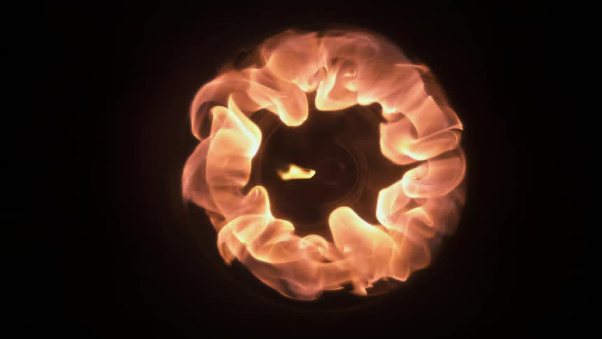 Flames burst into a circular shape in the darkness