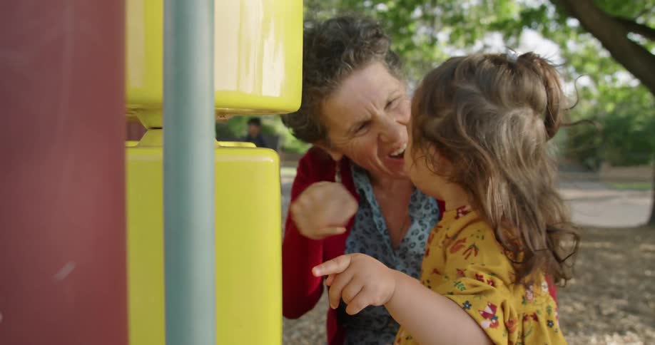 A woman and child play in the playground