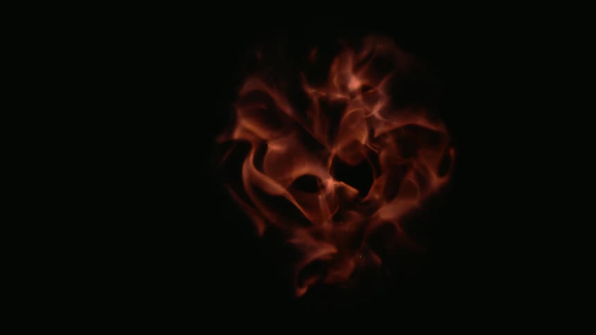 Orange fire flames dissipating on a black background