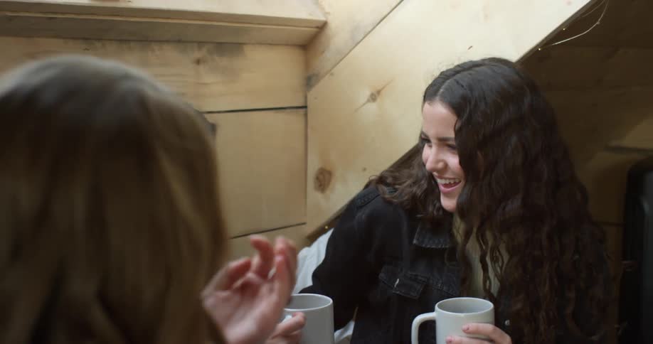 Three women talk and drink together