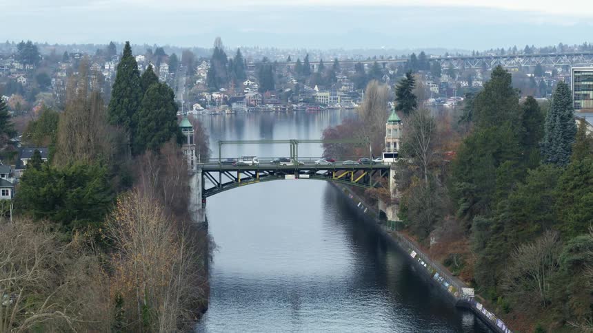 Commuters travel on a drawbridge over a river between neighborhoods and downtown