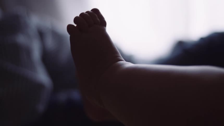 A baby laying on a bed