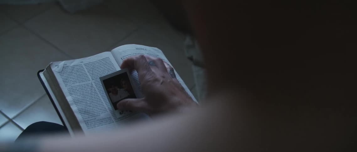 A person opening a book to find a picture inside it