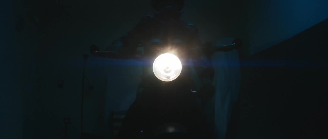 A person is riding a motorcycle at night