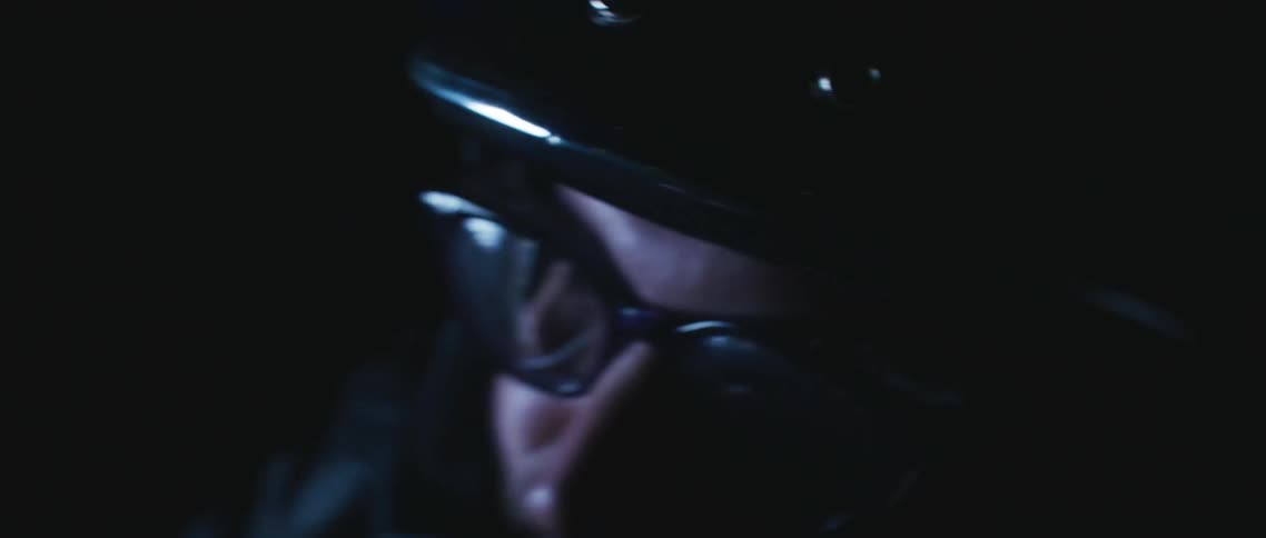 Light reflects off the goggles and helmet of a person as they are shaken by turbulence