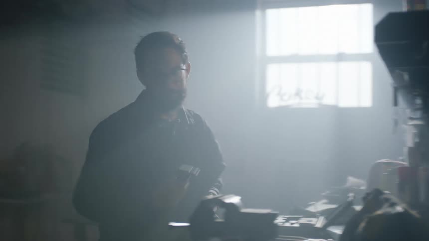 Group of mechanics working on a dimly lit repair shop