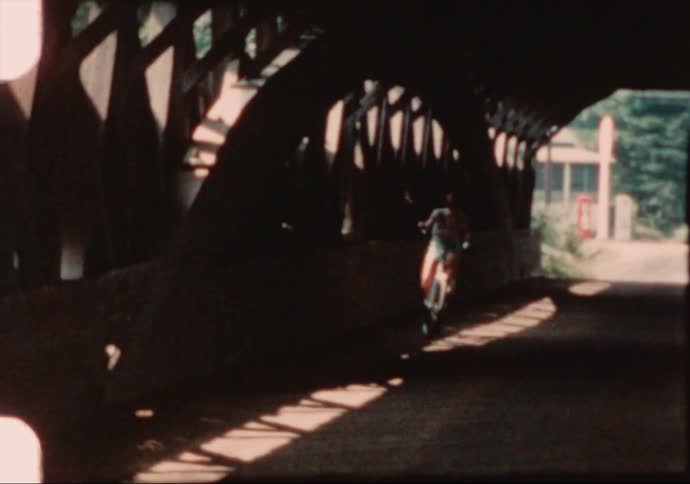A woman riding a bike in a tunnel