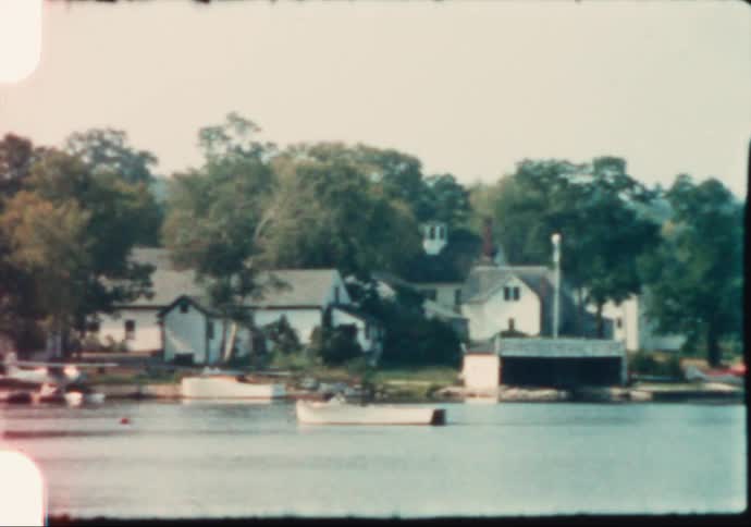 A seaplane is docked at a small Maine lakeside town during summertime