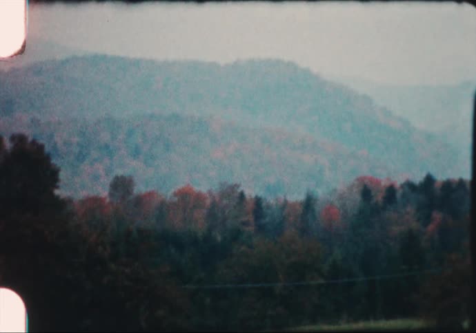 A mailbox and barn on a rural farm on an autumn day