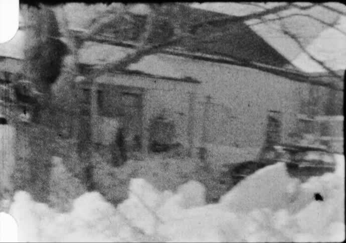 House and barn on the snow covered countryside caught in black and white film
