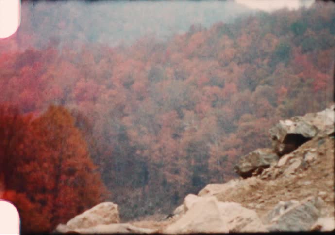 Footage of a mountain is displayed in fall