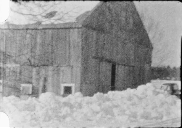Barn in a snow covered rural area caught on black and white film