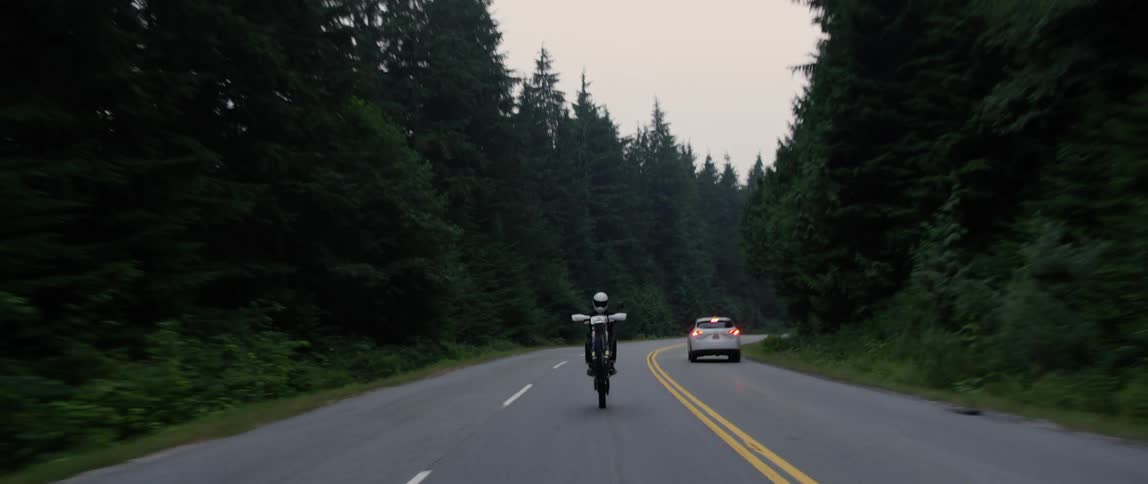 A person does a pop wheelie on a motorcycle