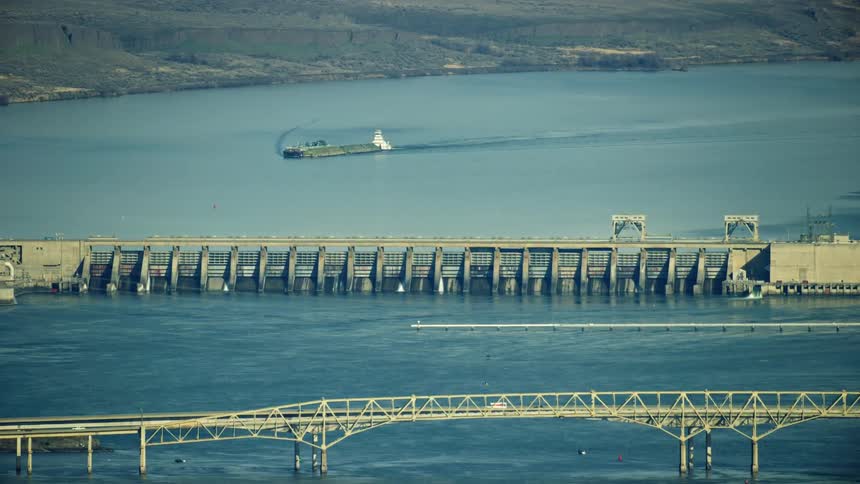 McNary Dam and Umatilla Bridge as seen from high in the air in this tight zoom aerial of the Lower Columbia River in Eastern Oregon and Washington