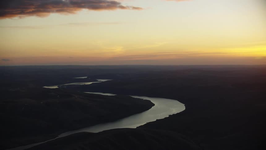 Sunset glow illuminates the Lower Snake River near the tri-cities in eastern Washington as the river water glimmers in the setting sun