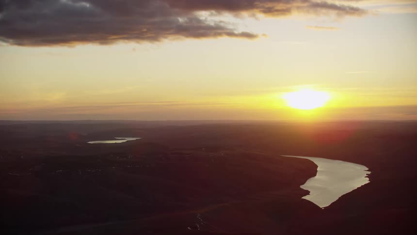 Slow zoom out reveal aerial at sunset of the lower snake river as it flows west towards the Columbia River, the same route migrating salmon swim