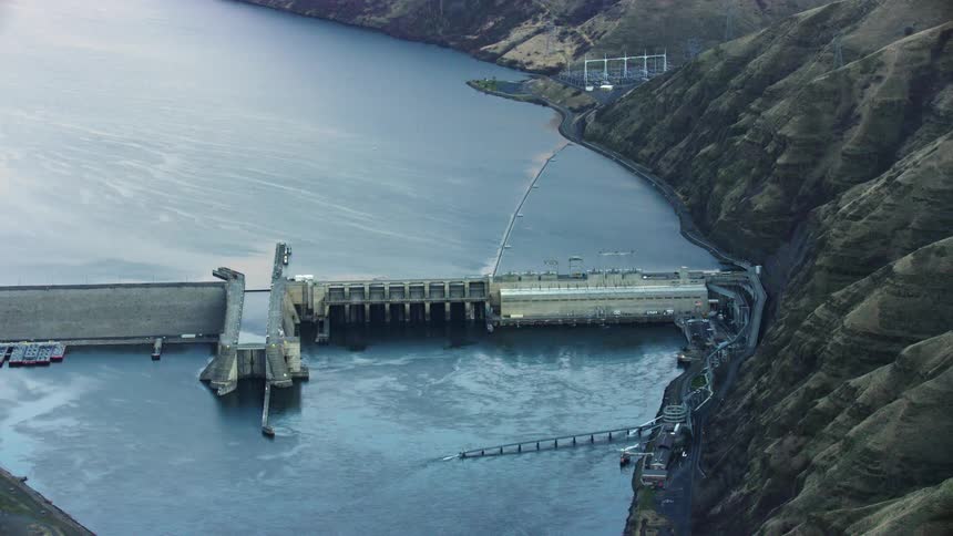 Lower Granite Dam is seen obstructing the Lower Snake River near Lewiston Idaho in this revealing aerial shot of the Snake River at sunset