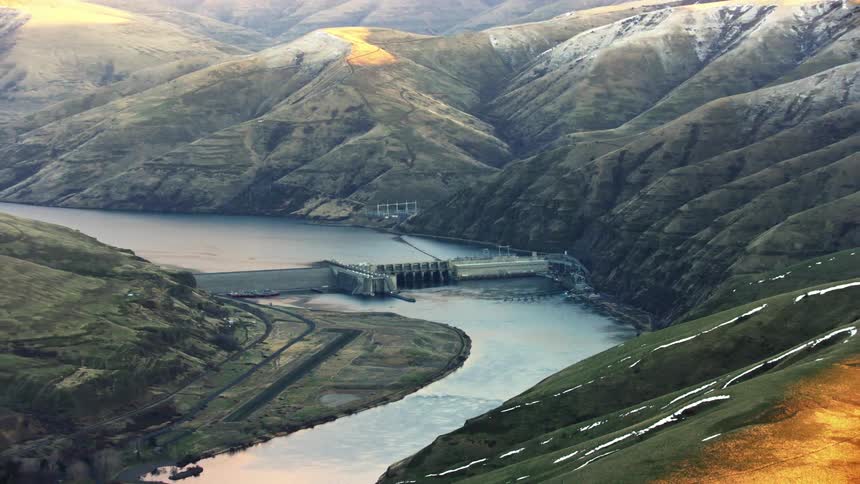 Zoom reveal of Granite Dam impounding the Lower Snake River near Lewiston, Idaho as the camera reveals the vast scene in the river valley