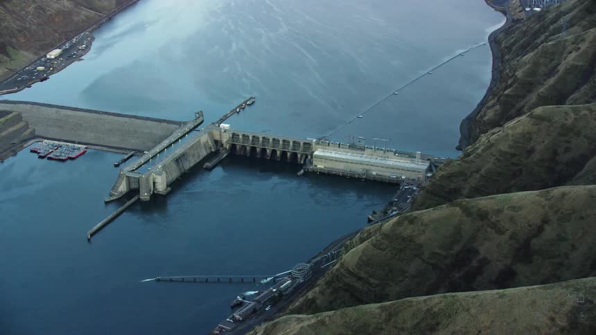 Aerial view of a granite dam on the lower snake river at sunset in winter showing the impact of this run of river dam
