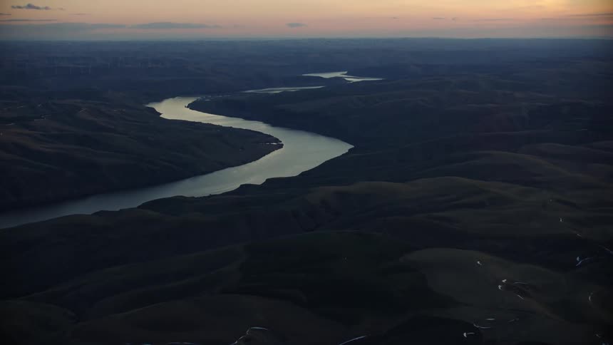 Slow tilt up of the Lower Snake River as it flows west towards the Columbia river at sunset in beautiful blue hour light
