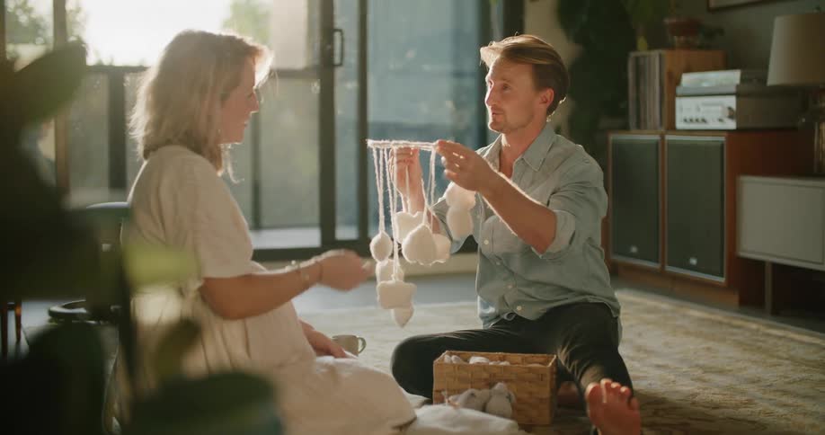 A husband and wife sit together looking at items