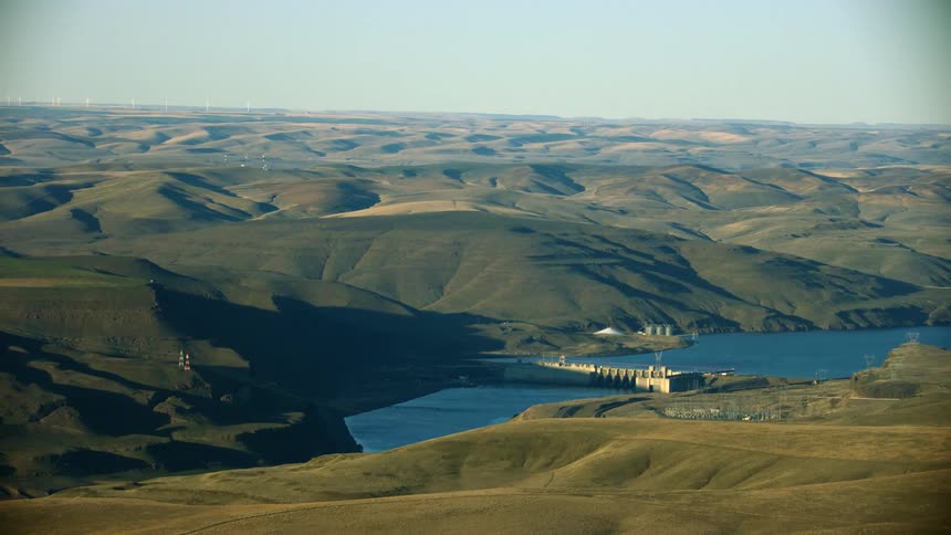 Lower Monumental Dam on the Lower Snake River as seen from high above the Palouse grass hills in evening light