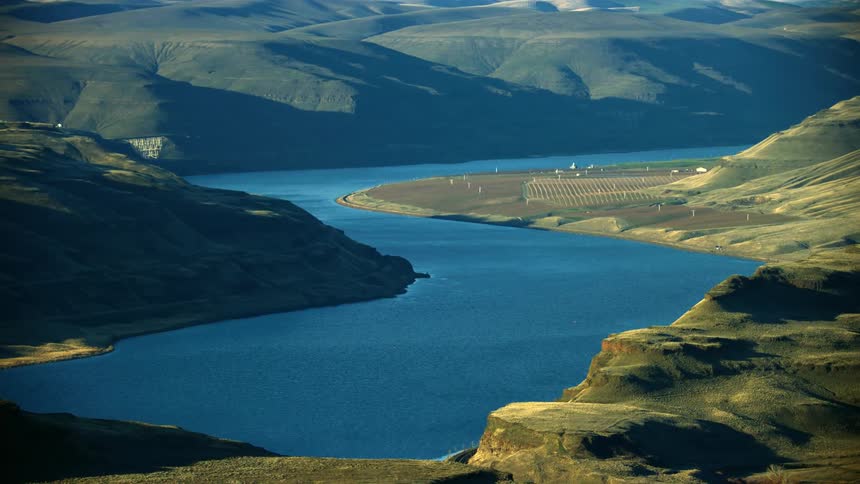 The Lower Snake River agricultural land as seen from high in the air and a calm sunny day with apples, peaches and cheeries growing on the side of the river