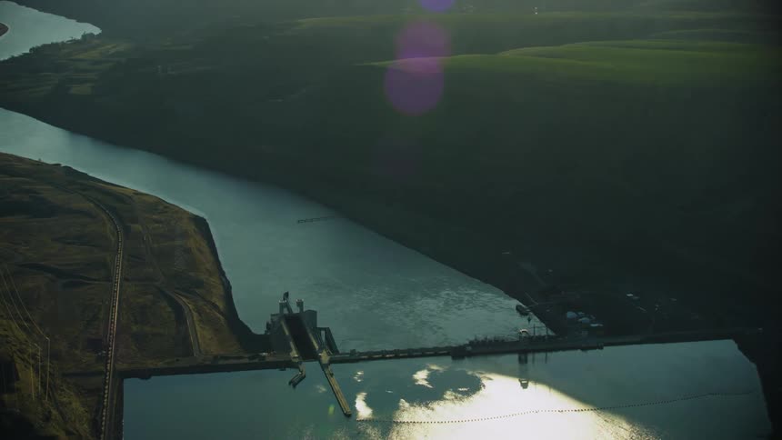 Lower Monumental dam on the Lower Snake River as seen from high above aerial in golden hour stunning light revealing the impact on the once free flowing river
