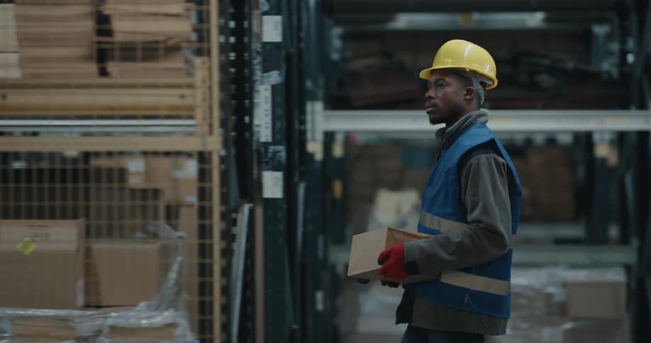 A man that is walking around in a warehouse