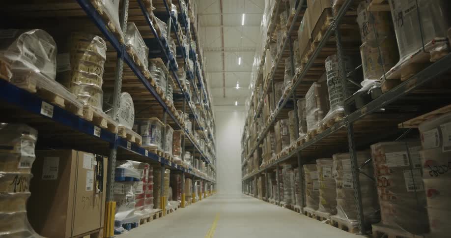 The shelves in the warehouse are full of boxes