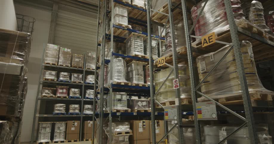 Boxes are stacked on shelves in a warehouse
