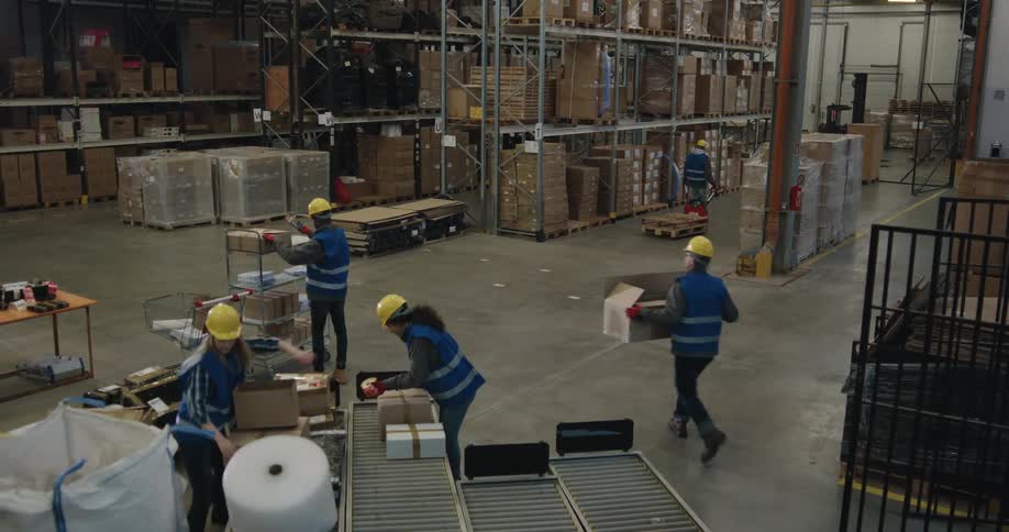 People working in a warehouse putting together boxes and packing items