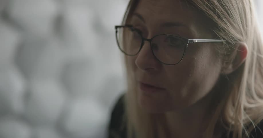 A woman talking to a coworker in the office