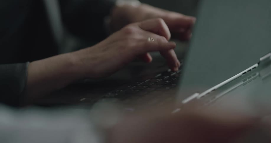 A person is typing on a laptop
