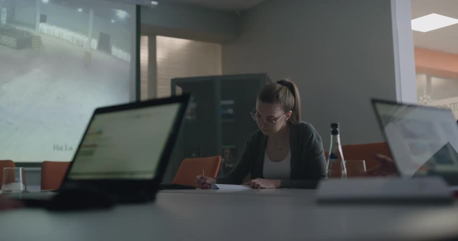 Group of people talking on a meeting in an office with a bit display on the wall