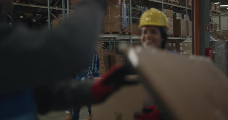 Employees are walking around a warehouse