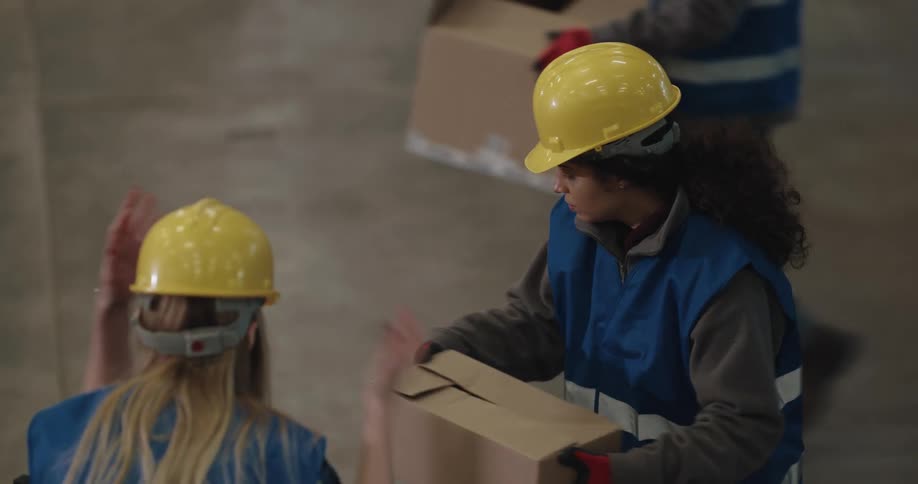 Two women pack boxes in the factory