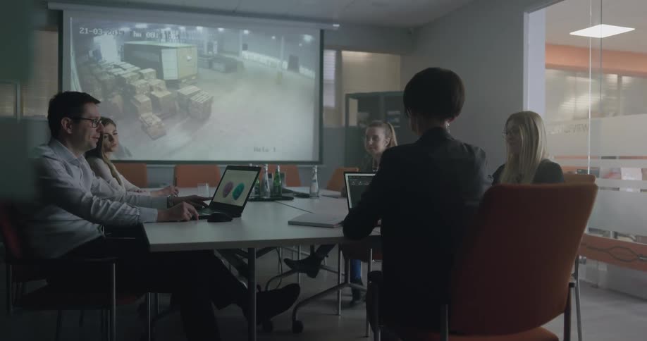 A group of workers sitting at a table in an office
