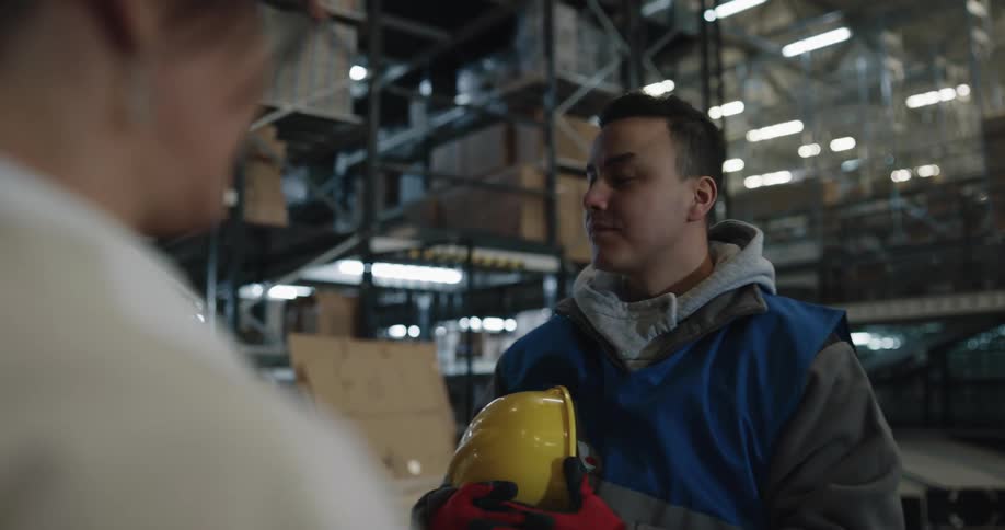 Two coworkers talk in the warehouse