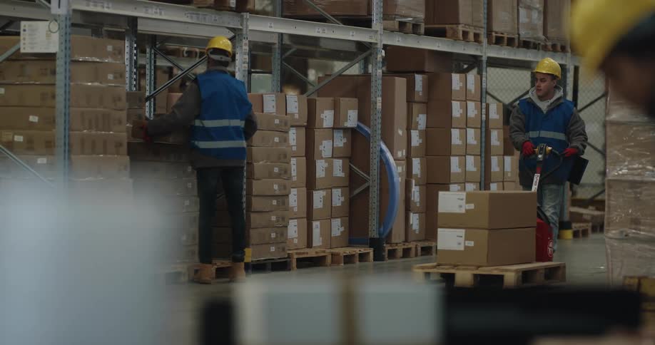 A group of workers loading boxes in a warehouse
